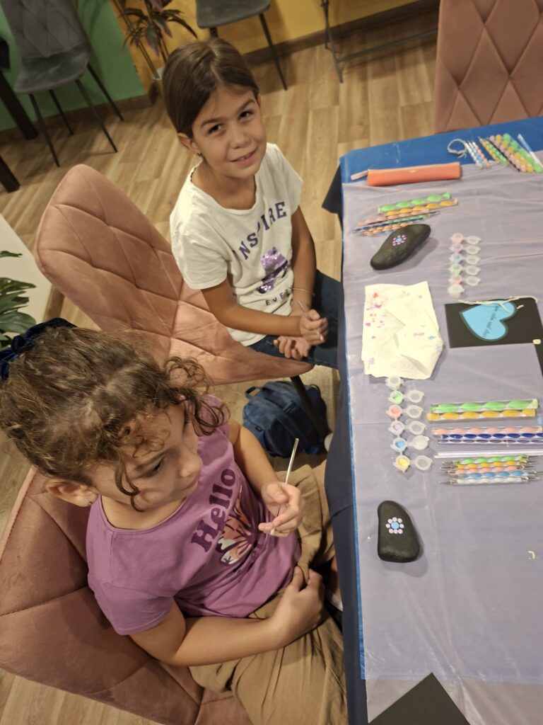 Children painting colorful mandala stones during the Mandala Dot Art Kids Workshop in Malta.